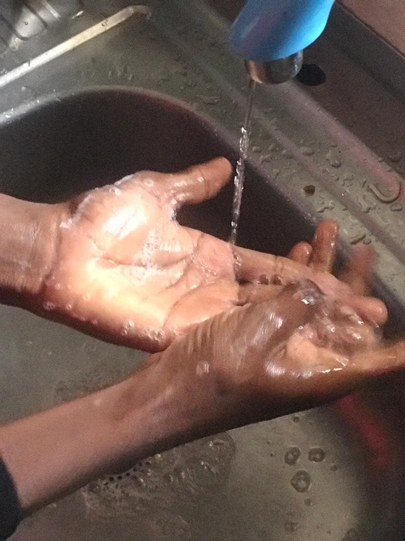 A clinician performing a surgical hand scrub